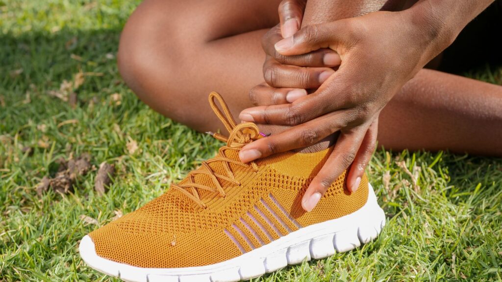 a person s hands holding ankle