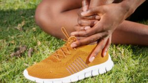 a person s hands holding ankle