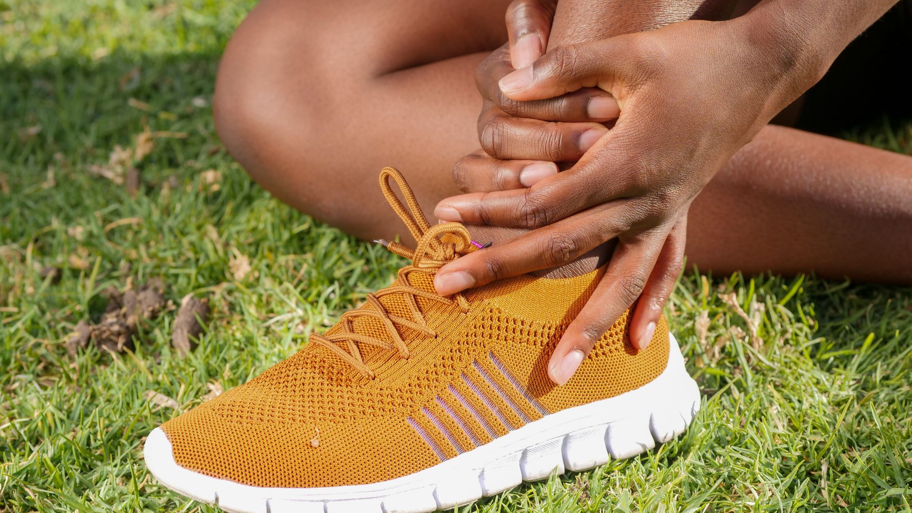 a person s hands holding ankle