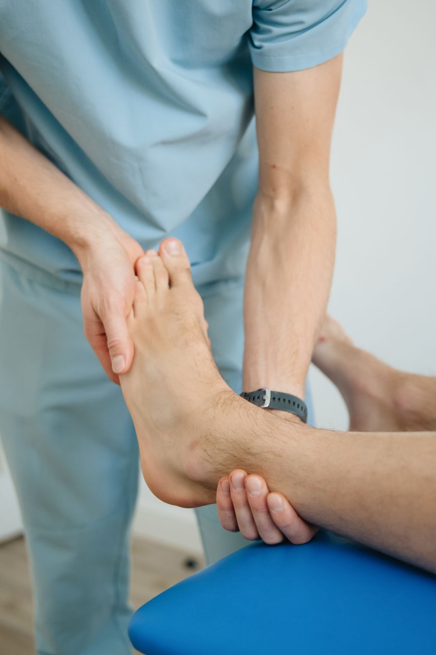 physiotherapist massaging foot